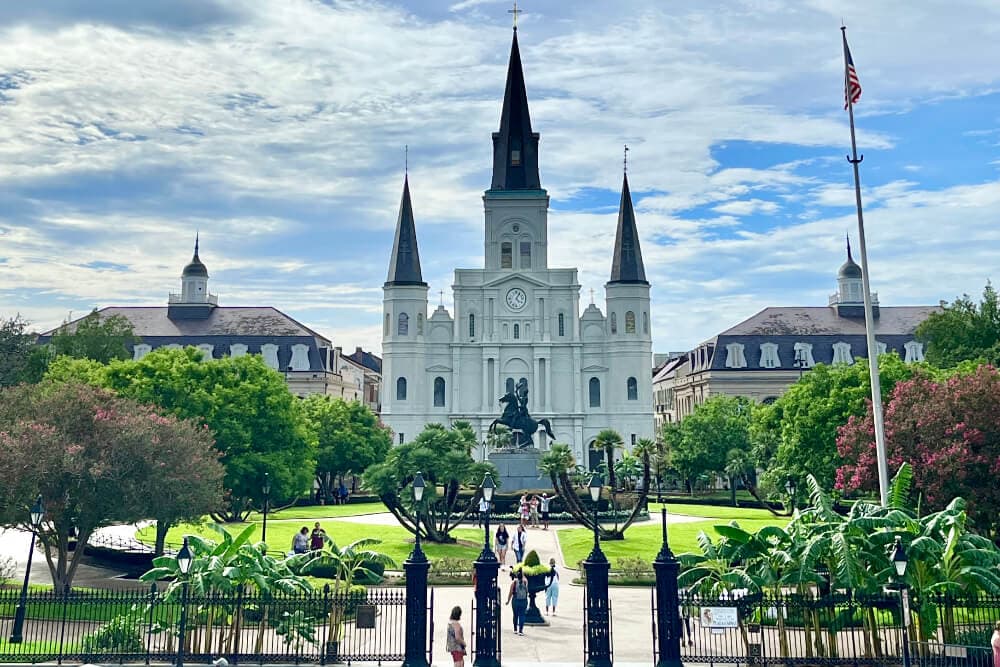 Jackson Square in New Orleans, featuring the St. Louis Cathedral and lively greenery.