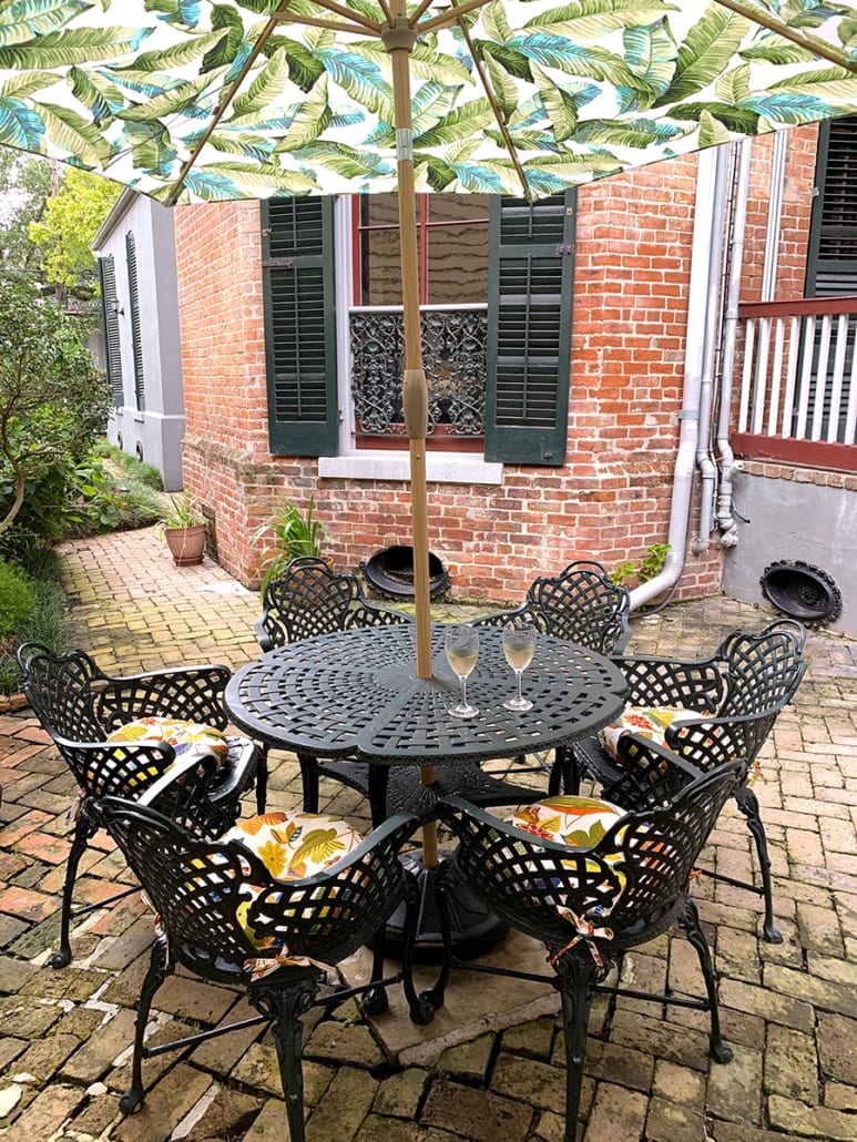 COURTYARD - table with open umbrella and wine